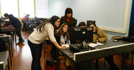 Sala com computadores e alunos