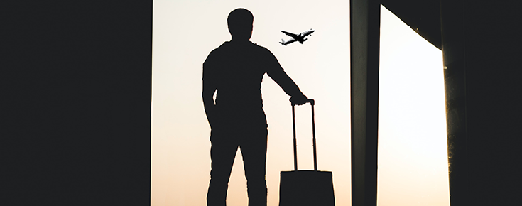 Conducting a PhD thesis in the International Cotutelle Regime Silhouette of a man at an airport, watching an aeroplane take off